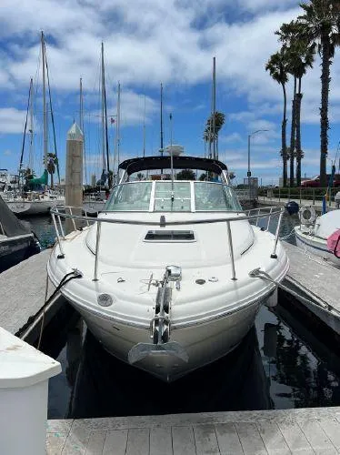 Slide: The Image of 2007 Sea Ray 290 Amberjack docked at marina with clear sky and palm trees. - 4