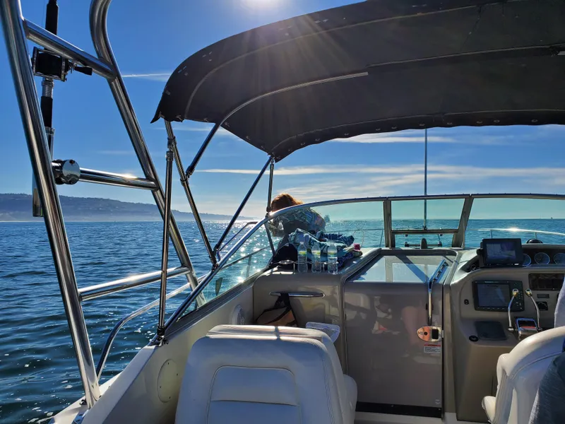Slide: The Image of 2007 Sea Ray 290 Amberjack boat cruising on a sunny day, with clear blue skies and ocean. - 7
