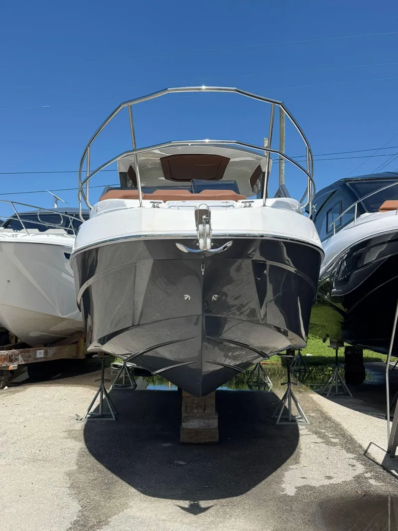 Slide: The Image of 2025 NX Boats NX340 yacht on display under clear blue sky. - 3