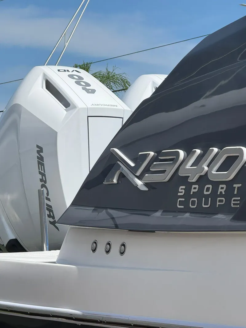 Slide: The Image of 2025 NX Boats NX340 Sport Coupe with Mercury engine, close-up view. - 6