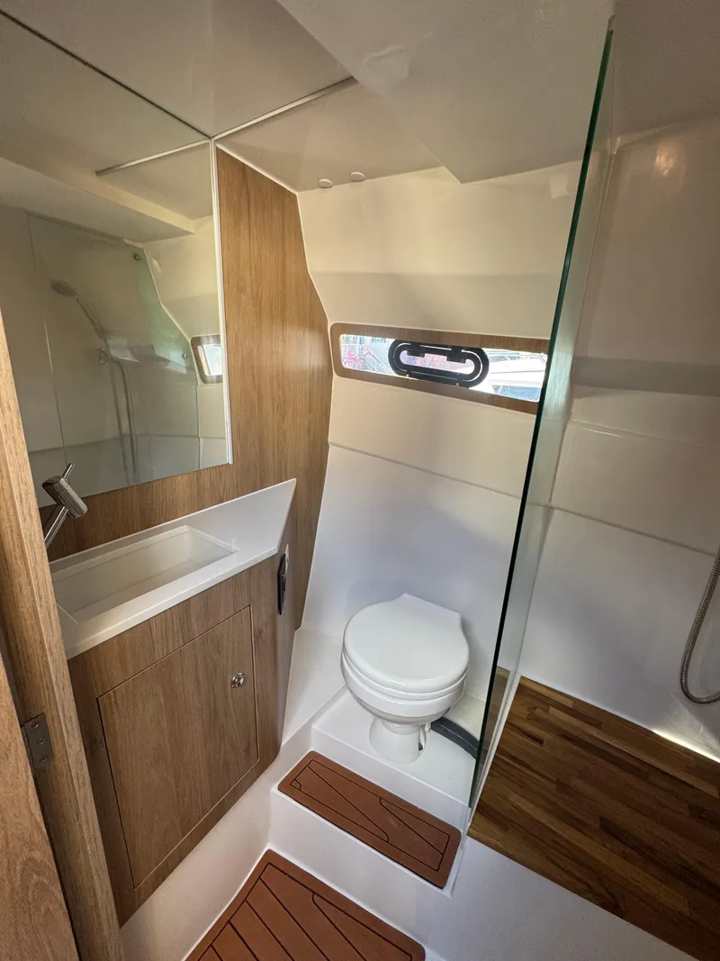 Slide: The Image of Modern bathroom in 2025 NX Boats NX340, featuring wood accents and sleek fixtures. - 9