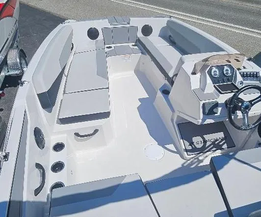 Slide: The Image of 2026 Starcraft SV 16 OB boat interior with seating and steering console. - 12