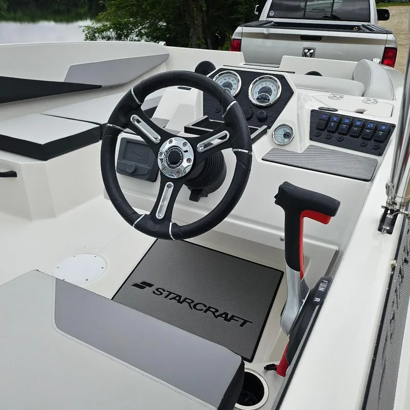 Slide: The Image of 2026 Starcraft SV 16 OB boat interior with steering wheel and control panel. - 2