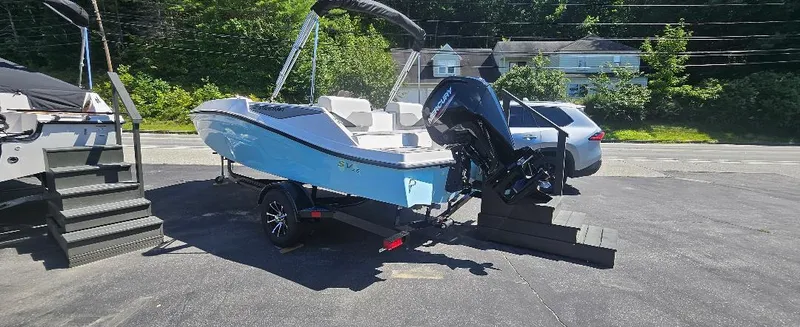 Slide: The Image of 2026 Starcraft SV 16 OB boat with outboard motor on a trailer, parked outdoors. - 5