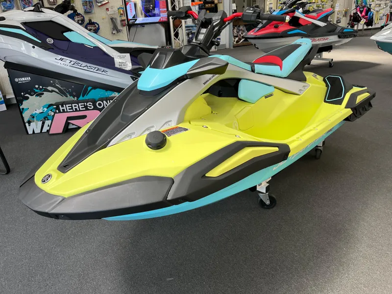 Slide: The Image of 2025 Yamaha WaveRunner JetBlaster PRO 3-Up in showroom, vibrant yellow and blue design. - 0