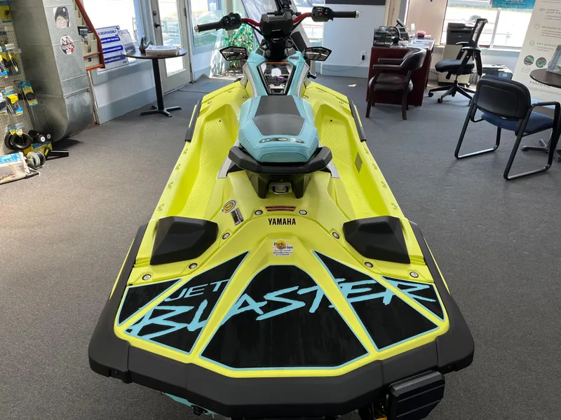 Slide: The Image of 2025 Yamaha WaveRunner JetBlaster PRO 3-Up in showroom, vibrant yellow and black design. - 1