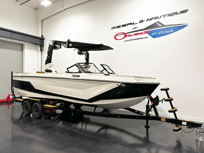 Slide: The Image of 2026 Nautique GS24 boat on trailer in showroom, Regal & Nautique of Orlando. - 2
