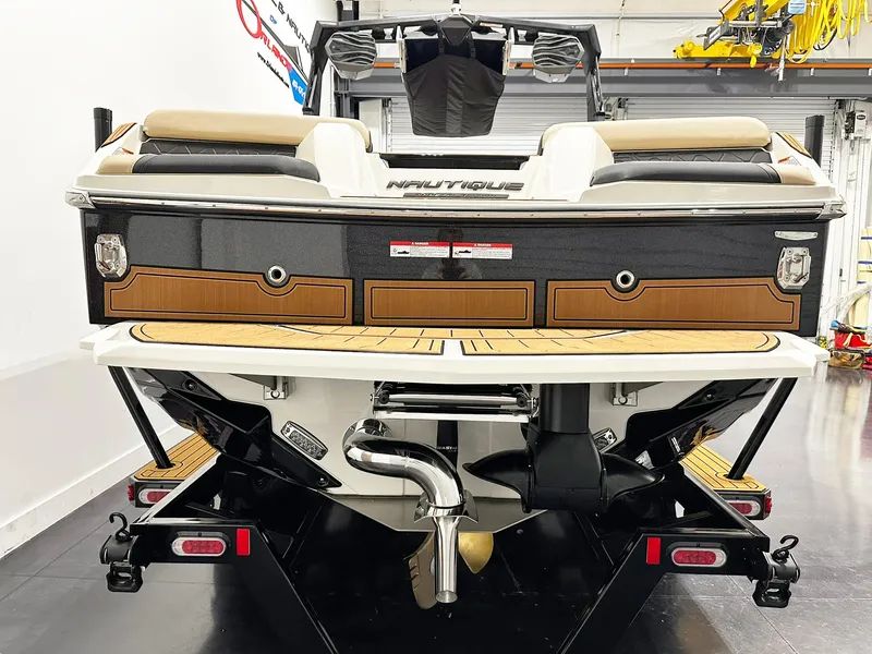 Slide: The Image of 2026 Nautique GS24 boat rear view in a showroom, showcasing sleek design and modern features. - 3