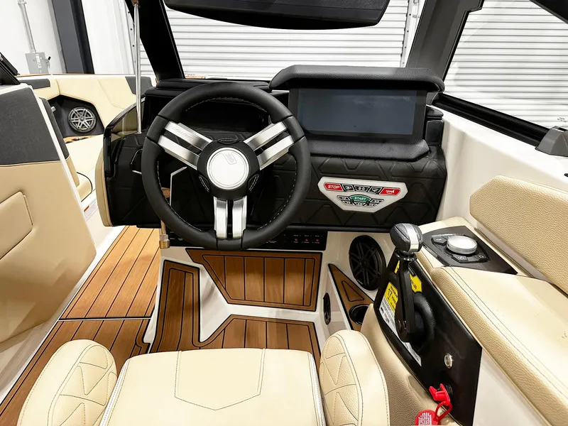 Slide: The Image of Interior of 2026 Nautique GS24 boat with modern steering and control panel. - 8