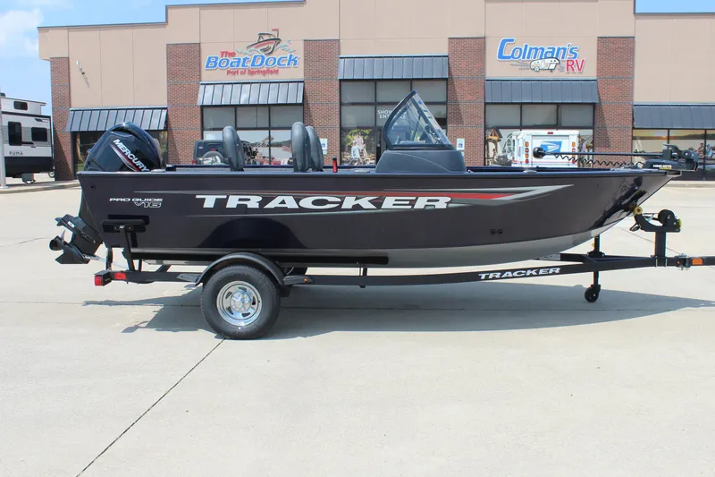 The Image of 2026 Tracker Pro Guide V-16 WT boat on trailer outside dealership. - 0