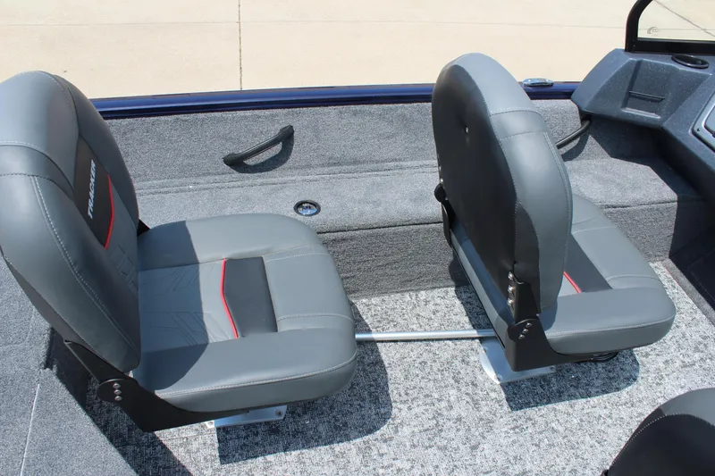 Slide: The Image of 2026 Tracker Pro Guide V-16 WT boat interior with two gray seats and carpeted flooring. - 10