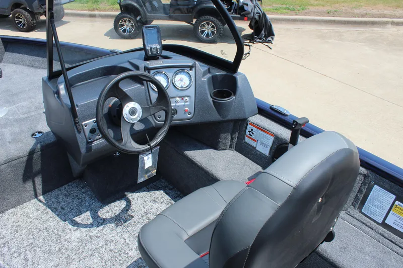 Slide: The Image of 2026 Tracker Pro Guide V-16 WT boat interior with steering wheel and dashboard controls. - 11
