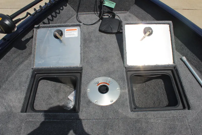 Slide: The Image of 2026 Tracker Pro Guide V-16 WT boat storage compartments and control panel. - 14