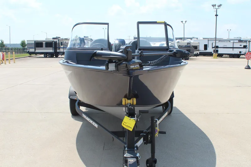 Slide: The Image of 2026 Tracker Pro Guide V-16 WT boat on trailer in parking lot. - 2