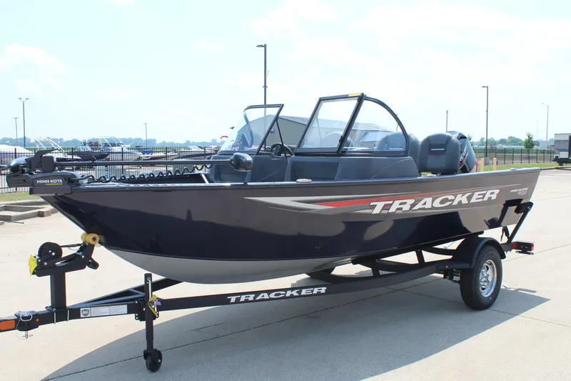 Slide: The Image of 2026 Tracker Pro Guide V-16 WT boat on trailer, parked outdoors. - 3