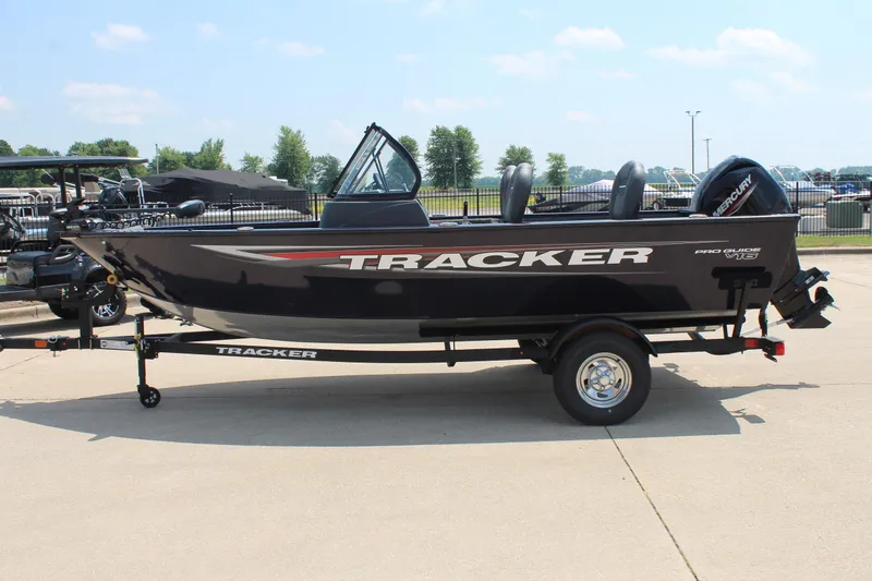 Slide: The Image of 2026 Tracker Pro Guide V-16 WT boat on trailer, parked outdoors. - 4
