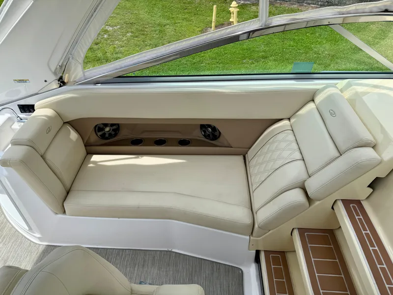 Slide: The Image of 2019 Regal 28 Express boat interior with beige seating and speaker system. - 18
