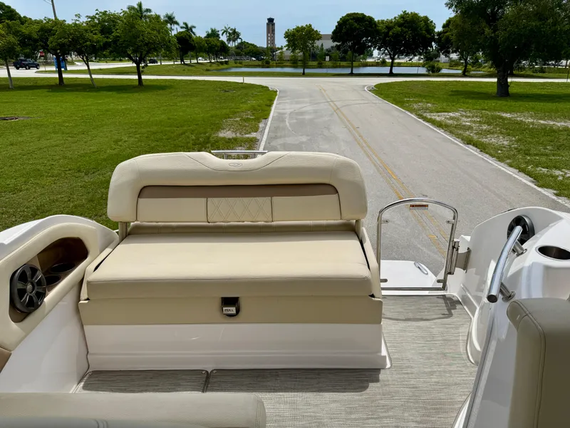 Slide: The Image of 2019 Regal 28 Express boat interior with beige seating and open deck view. - 20