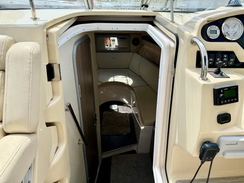 Slide: The Image of 2019 Regal 28 Express cabin interior with seating and control panel. - 23