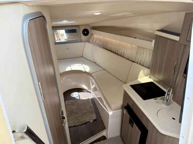 Slide: The Image of 2019 Regal 28 Express cabin interior with kitchenette and seating area. - 24