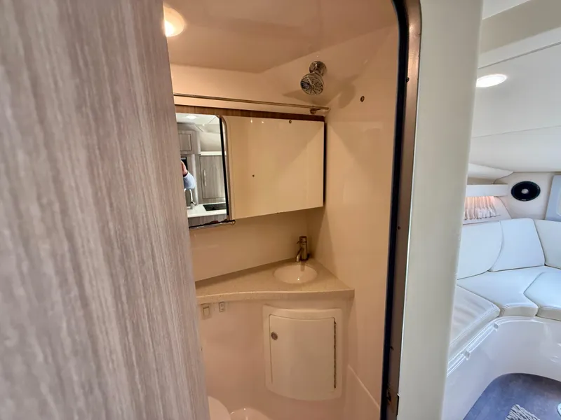 Slide: The Image of 2019 Regal 28 Express boat interior with bathroom and seating area. - 34