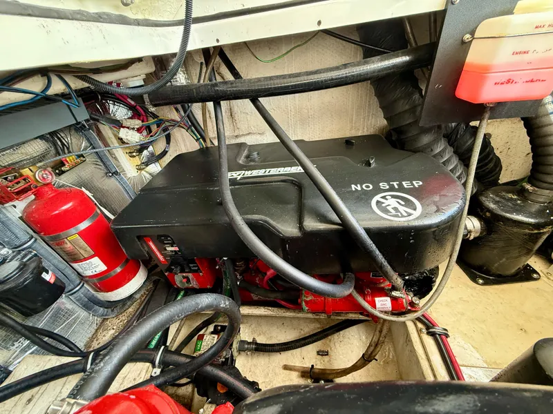 Slide: The Image of Engine compartment of a 2019 Regal 28 Express boat with fire extinguisher and wiring. - 41