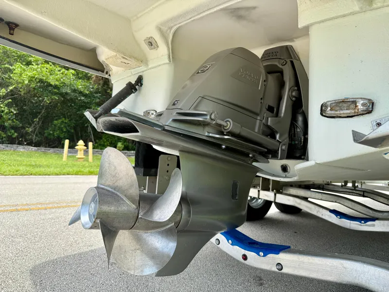 Slide: The Image of 2019 Regal 28 Express boat propeller and engine detail on trailer. - 42