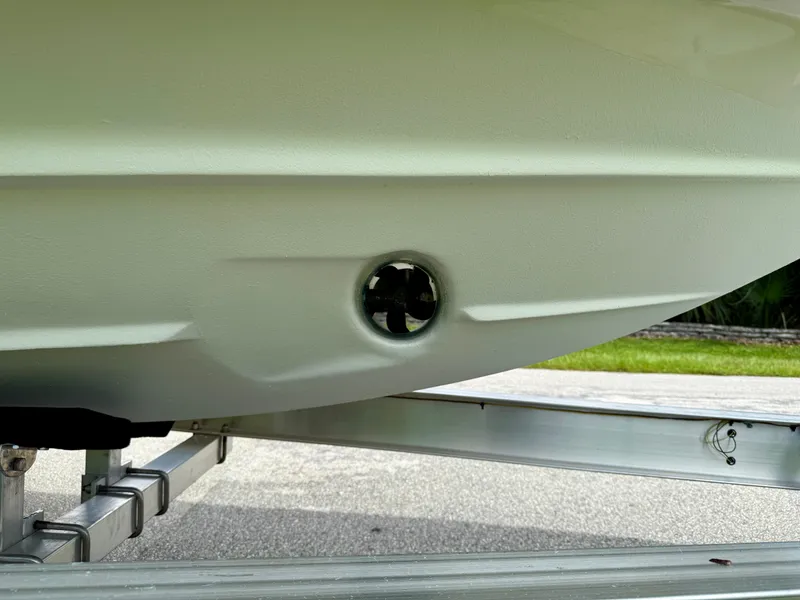Slide: The Image of 2019 Regal 28 Express boat hull on trailer, close-up view. - 44