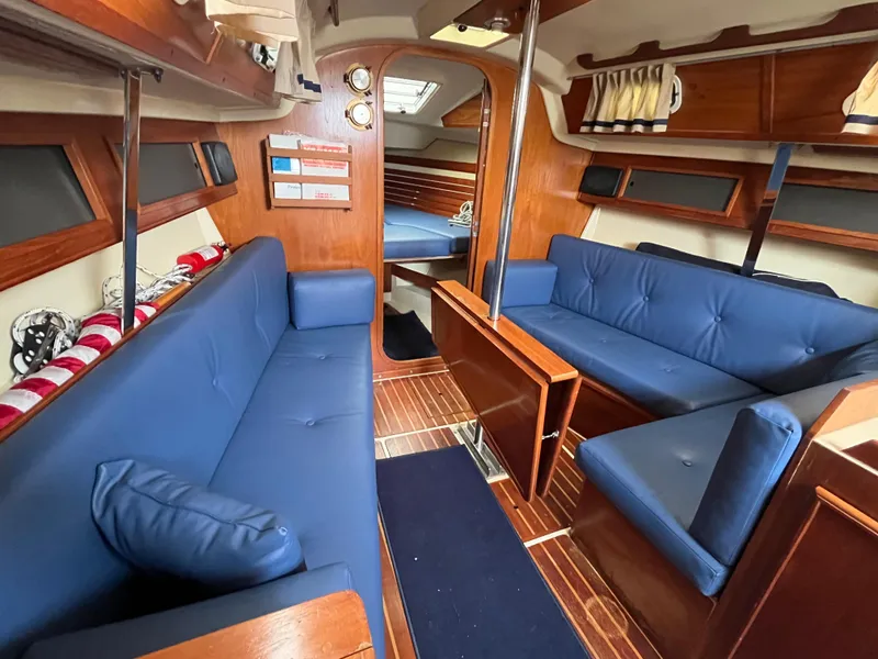 Slide: The Image of Interior of 1986 Pearson 33-2 sailboat with blue seating and wooden accents. - 17
