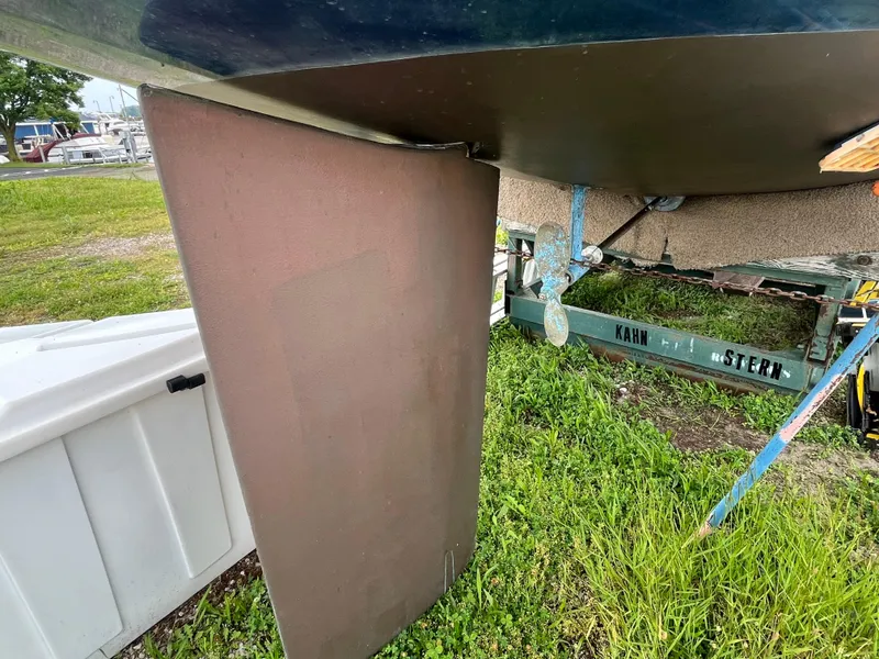 Slide: The Image of 1986 Pearson 33-2 sailboat keel and propeller on trailer, grassy background. - 3