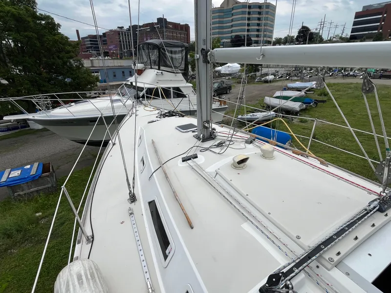 Slide: The Image of Pearson 33-2 sailboat from 1986 docked, with urban buildings in the background. - 30