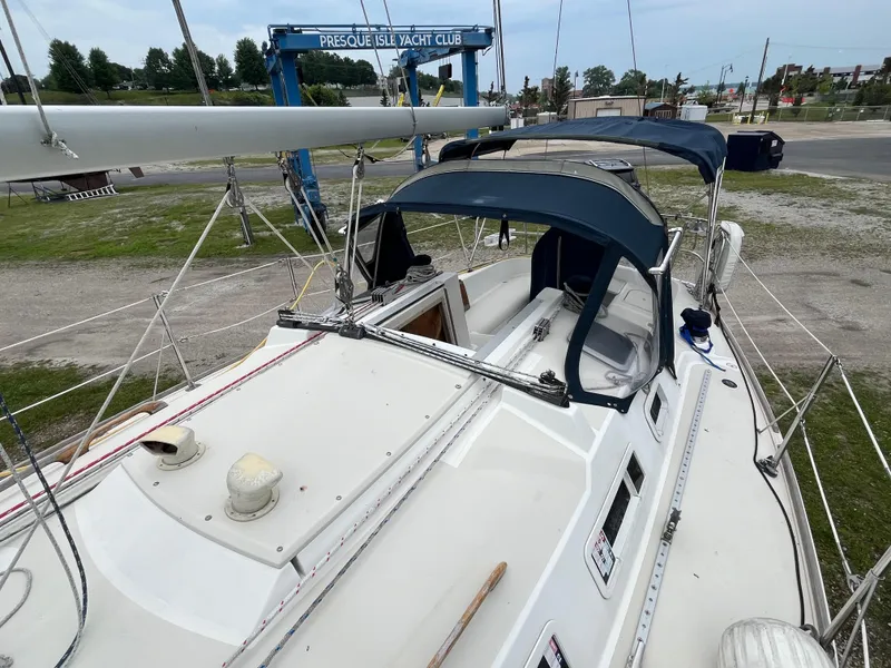 Slide: The Image of 1986 Pearson 33-2 sailboat at Presque Isle Yacht Club, featuring blue canvas covers. - 31