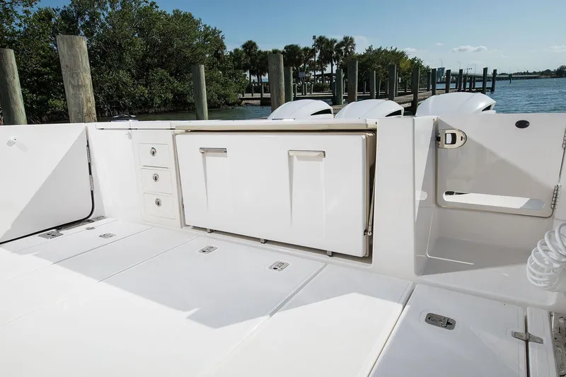 Slide: The Image of Manufacturer Provided Image: 2020 Pursuit S 368 Sport boat deck with storage compartments and outboard motors. - 10