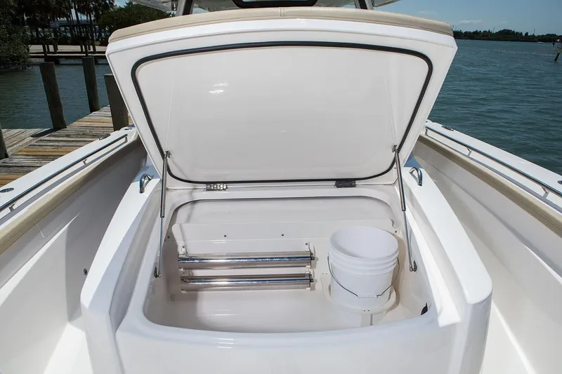 Slide: The Image of Manufacturer Provided Image: 2020 Pursuit S 368 Sport boat storage compartment open by the dock. - 13
