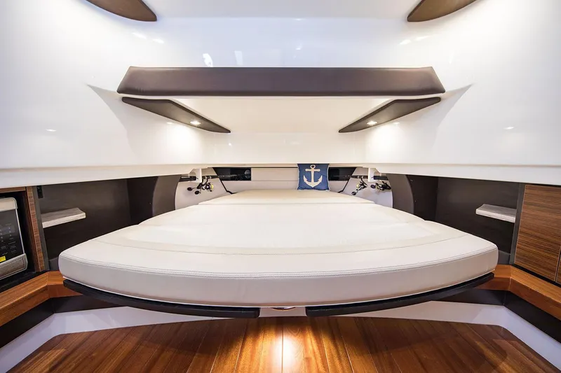 Slide: The Image of Manufacturer Provided Image: 2020 Pursuit S 368 Sport boat interior cabin with bed and wooden flooring. - 15
