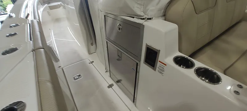Slide: The Image of 2020 Pursuit S 368 Sport boat interior with seating, storage, and cup holders. - 18