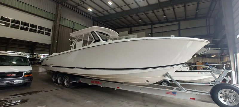 Slide: The Image of 2020 Pursuit S 368 Sport boat on trailer in indoor storage facility. - 2