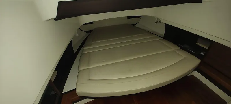 Slide: The Image of 2020 Pursuit S 368 Sport cabin interior with beige cushioned seating. - 20