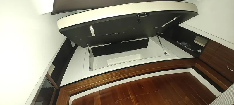 Slide: The Image of 2020 Pursuit S 368 Sport cabin interior with wooden flooring and storage compartments. - 21