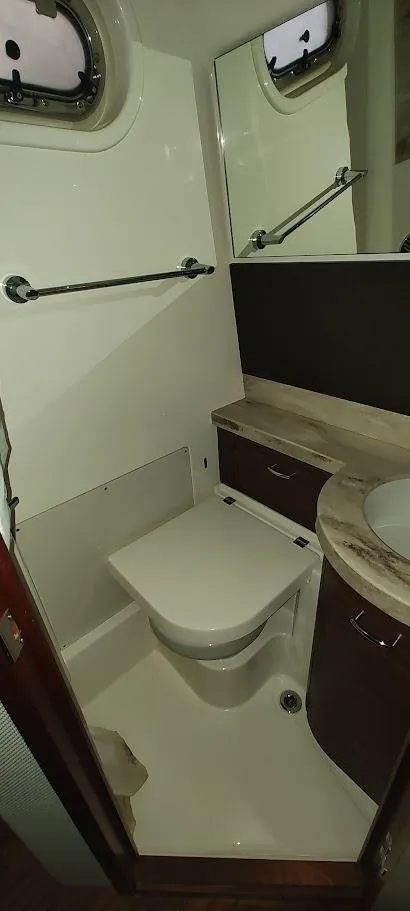 Slide: The Image of 2020 Pursuit S 368 Sport boat bathroom with toilet, sink, and mirror. - 22