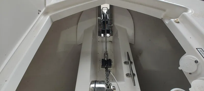 Slide: The Image of Anchor compartment of 2020 Pursuit S 368 Sport boat, showcasing chain and winch system. - 26