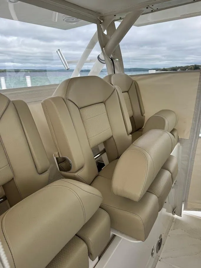 Slide: The Image of 2020 Pursuit S 368 Sport boat interior with beige leather seats. - 33