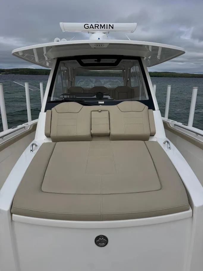 Slide: The Image of 2020 Pursuit S 368 Sport boat with Garmin equipment, featuring a spacious deck and seating area. - 35