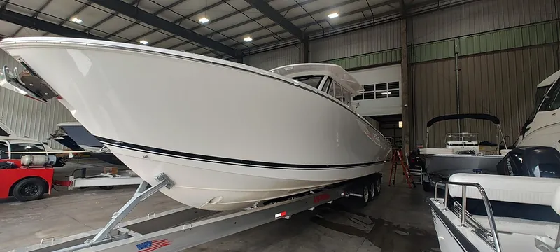 Slide: The Image of 2020 Pursuit S 368 Sport boat in a warehouse on a trailer. - 4