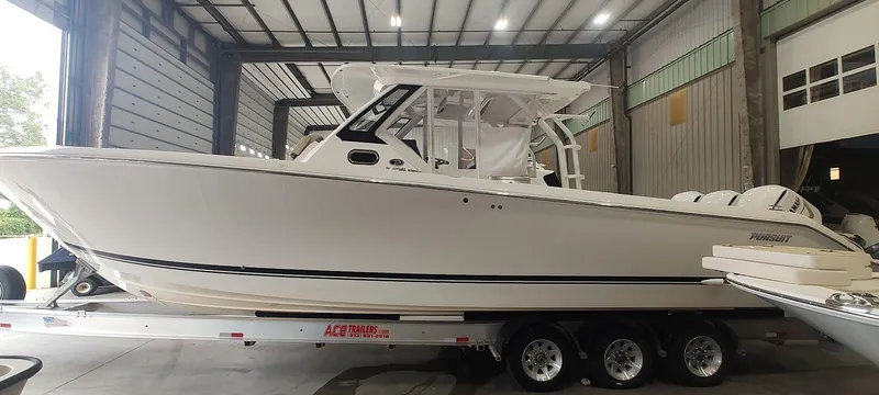 Slide: The Image of 2020 Pursuit S 368 Sport boat on trailer in a warehouse setting. - 6