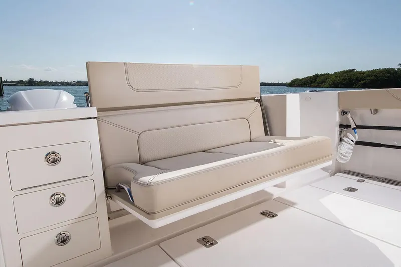 Slide: The Image of Manufacturer Provided Image: 2020 Pursuit S 368 Sport boat interior with beige seating and storage drawers. - 9