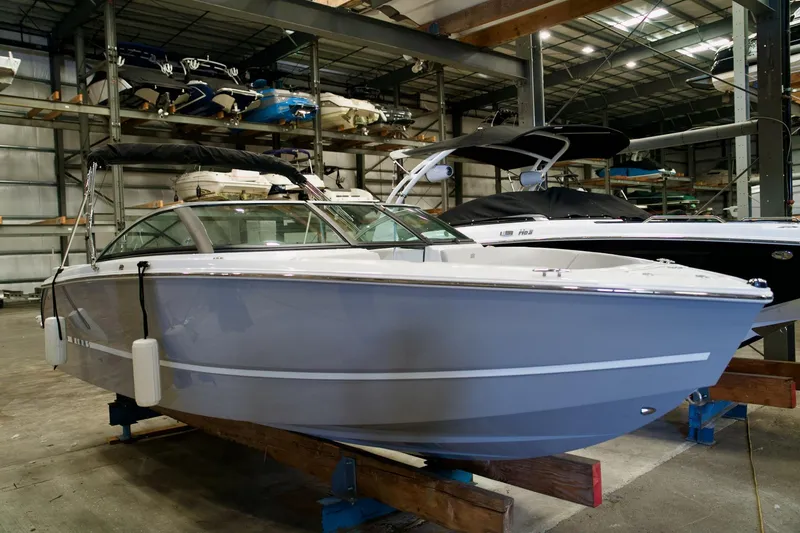The Image of 2026 Four Winns H2 boat in indoor storage, showcasing sleek design and modern features. - 1