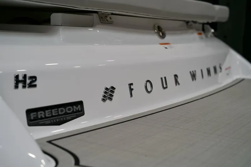 Slide: The Image of 2026 Four Winns H2 boat, Freedom Series branding, close-up view. - 10