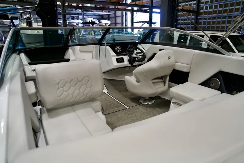 Slide: The Image of Interior of 2026 Four Winns H2 boat with modern white seating and sleek design. - 12