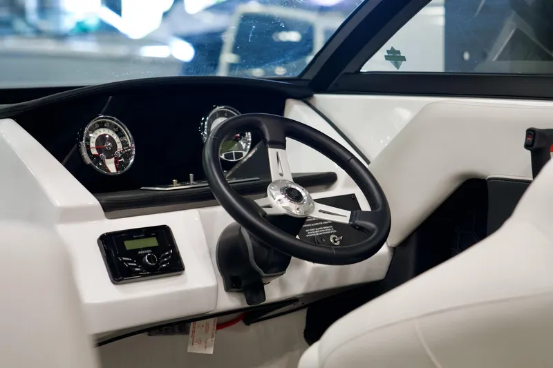 Slide: The Image of 2026 Four Winns H2 boat dashboard with steering wheel and gauges. - 14